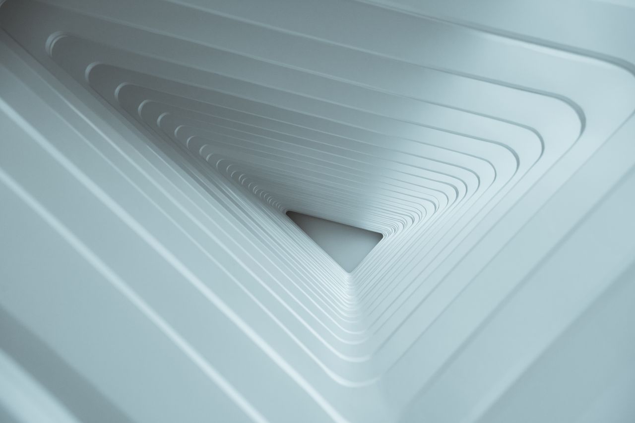 About Abstract view of futuristic white tunnel design with repetitive geometric patterns.